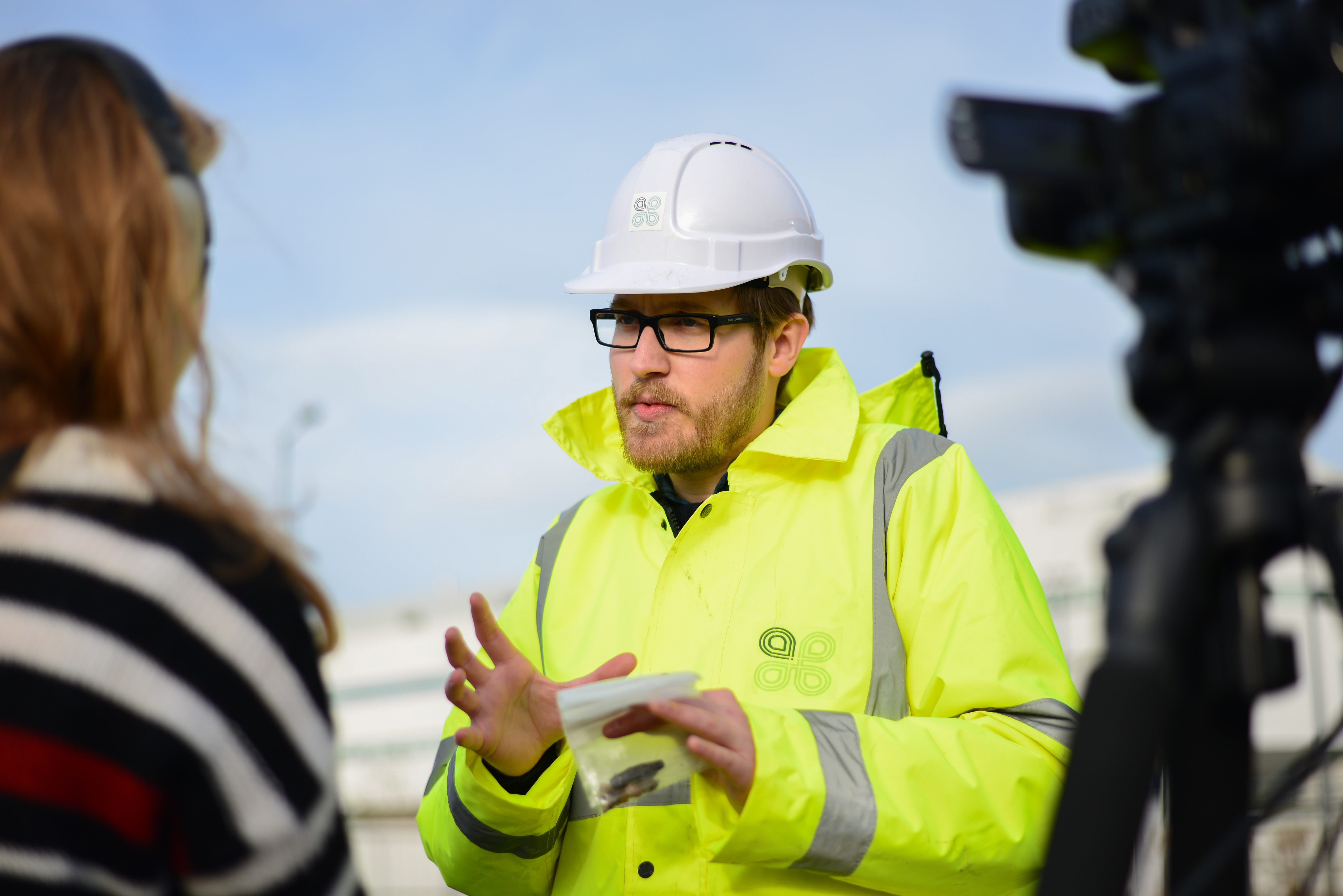 Image of a person in a hard hat and reflective coat