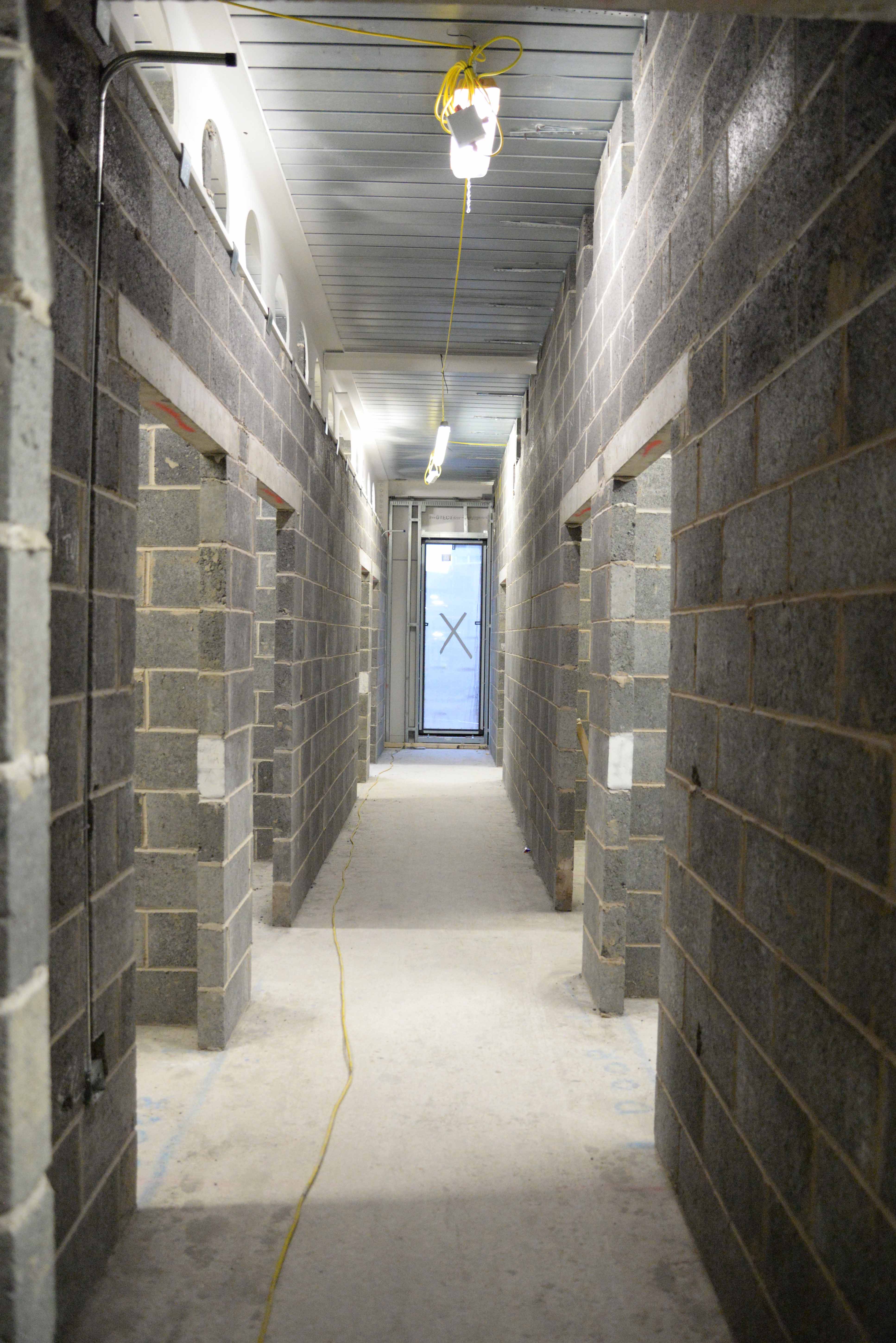Image of a long corridor, the walls are concrete