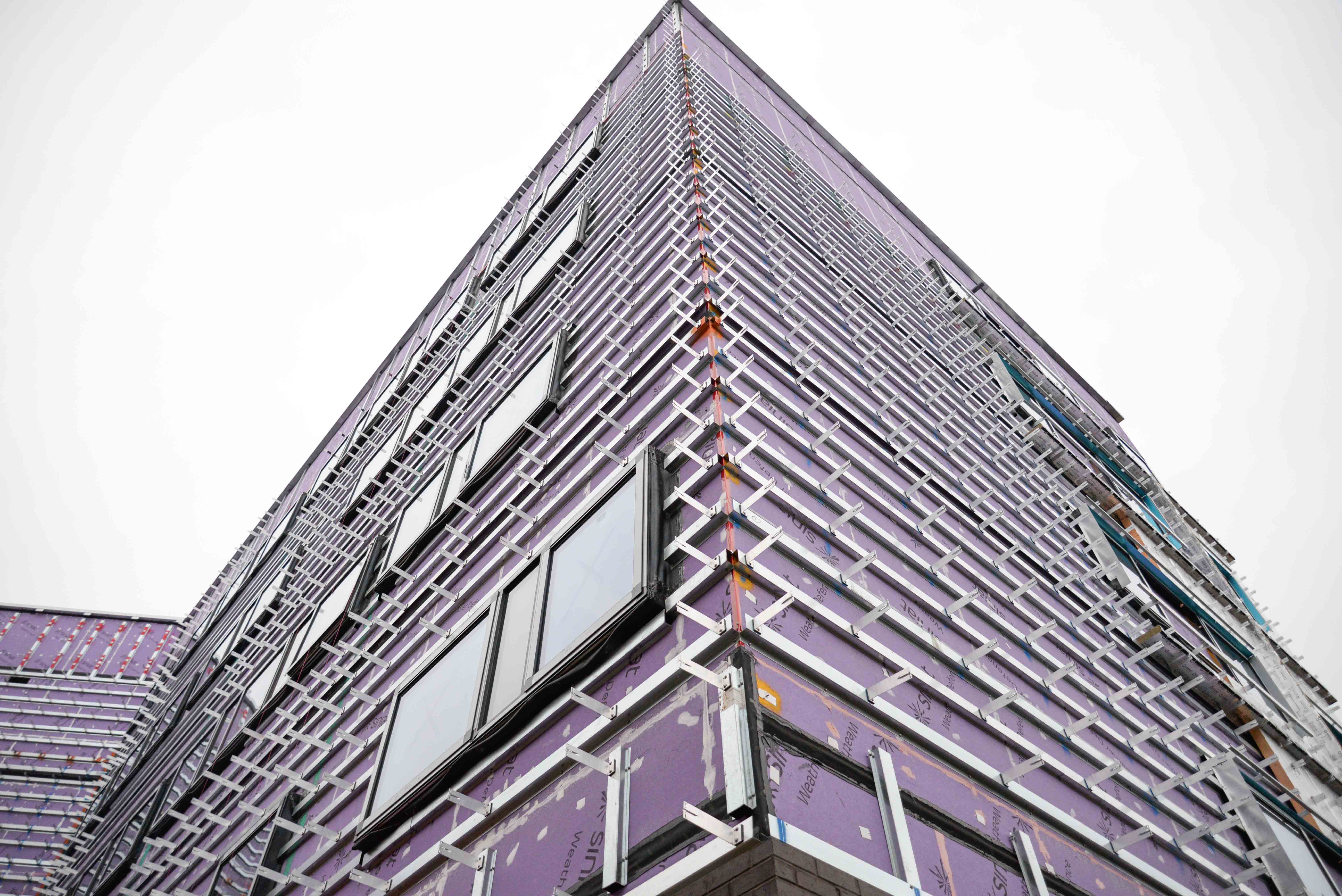 Image of purple insulation on the outside of a building