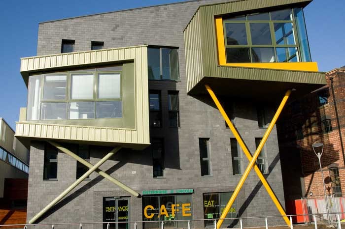 image of a modern looking grey, green and yellow building