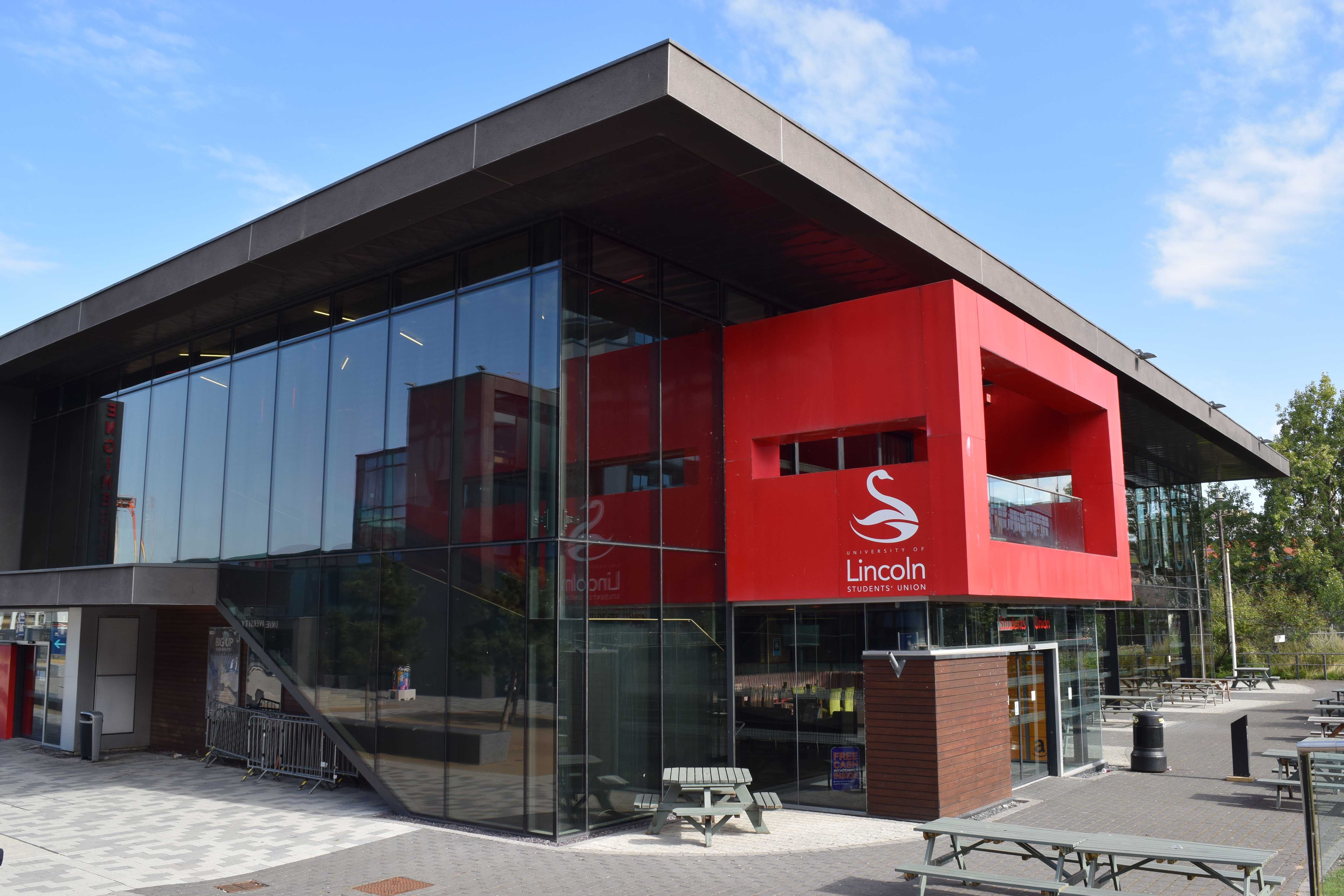 Image of a building with a glass wall and red platform