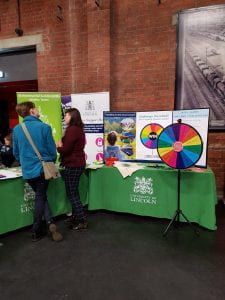 Two people stand at the Environmental stall at the University of Lincoln Refreshers Fayre