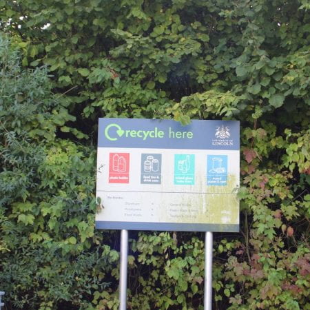 Image of sign with trees behind it