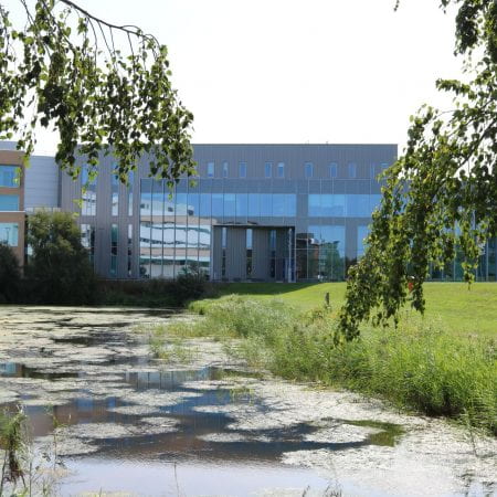 Image of the delph pond with the Isaac newton building in the background
