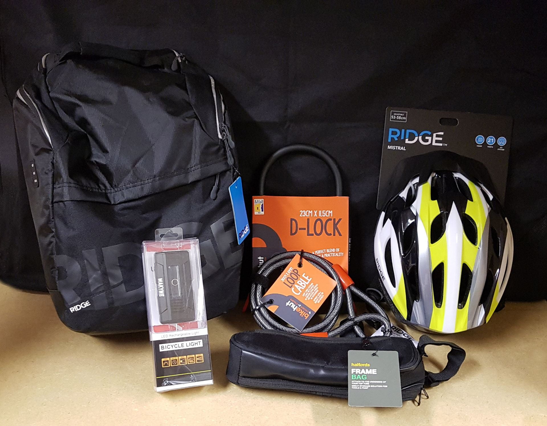 Image of cycling equipment, including a helmet, lock, lights and bag