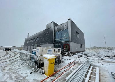 Image of a building in the snow with a grey sky behind it