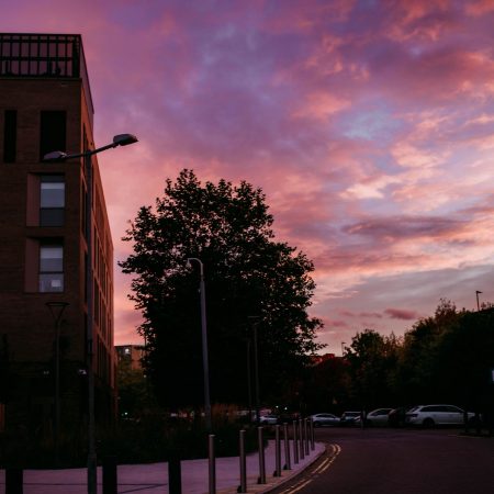 Image of a modern building against a sunset sky