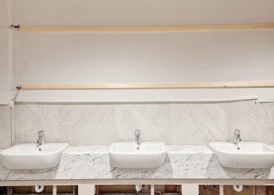 3 sinks on a marble style plinth.