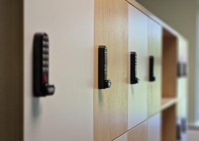 white and light brown wooden lockers with code key locks on the doors